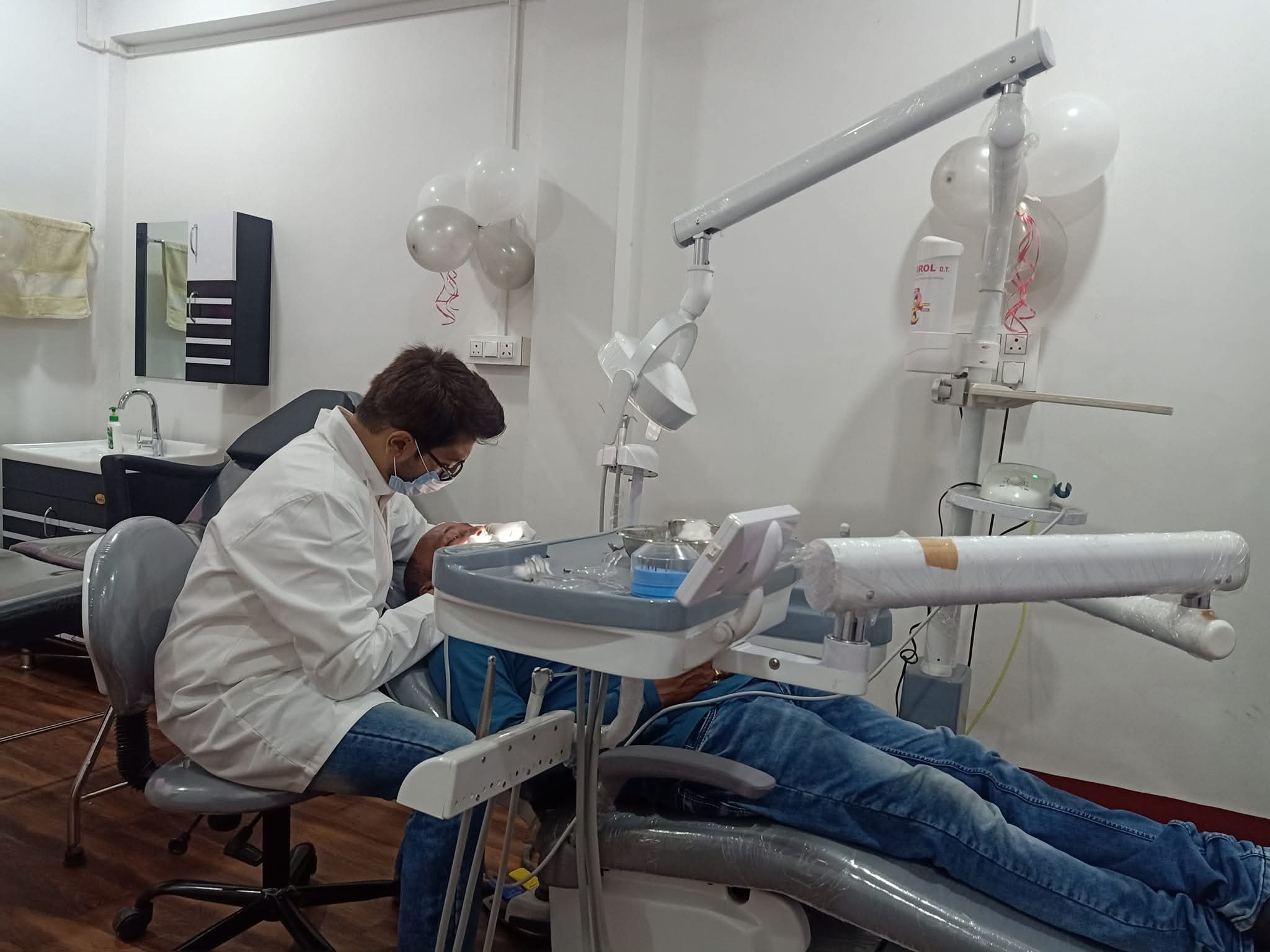 Dr. Souvik Ghosh Dutta Treating Patient in Dental Operatory Chair at CosmoDent